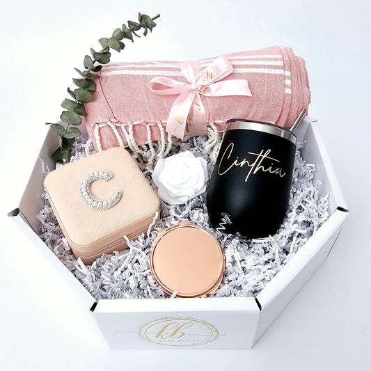 Spoil her with a personalized touch! Our curated gift box includes a custom jewelry box, a rose gold compact mirror and a personalized wine tumbler.