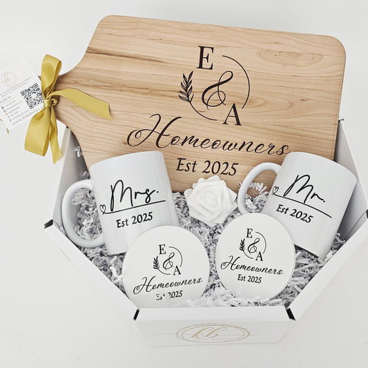 Set of personalized mugs and a wooden cutting board with 2 round ceramic coasters.