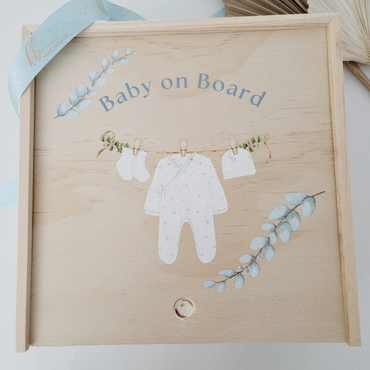 Custom wooden birth announcement box for newborns featuring a watercolor clothesline with a onesie and booties.