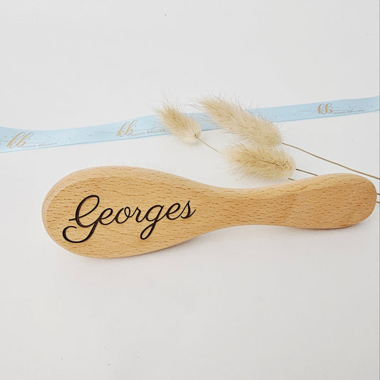 Custom baby hairbrush made of natural wood engraved with the name Georges.