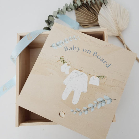Custom wooden birth announcement box for newborns featuring a watercolor clothesline with a onesie and booties.