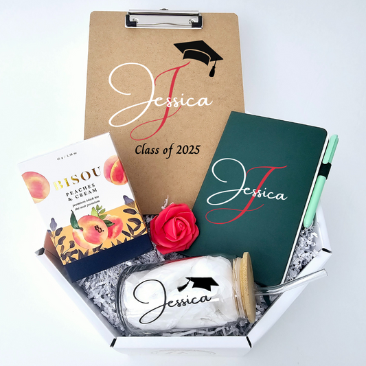 Congratulate the graduate with the gift of an elevated workspace. Our curated set includes a personalized notebook, personalized clipboard, sleek can-shaped glass with bamboo lid and straw, and gourmet tea – everything they need for a stylish and efficient start to their next adventure.