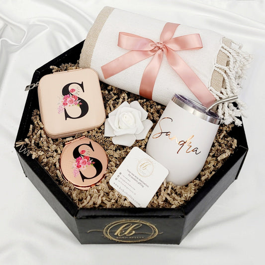 Spoil her with a personalized touch! Our curated gift box includes a custom jewelry box, a rose gold compact mirror and a personalized wine tumbler.
