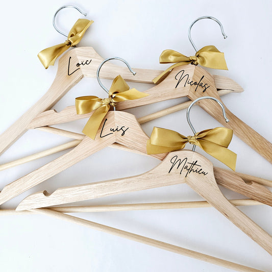 Personalized wooden cloth hangers. Crafted from high-quality wood, these hangers can be laser-engraved with names, initials, or special messages. 