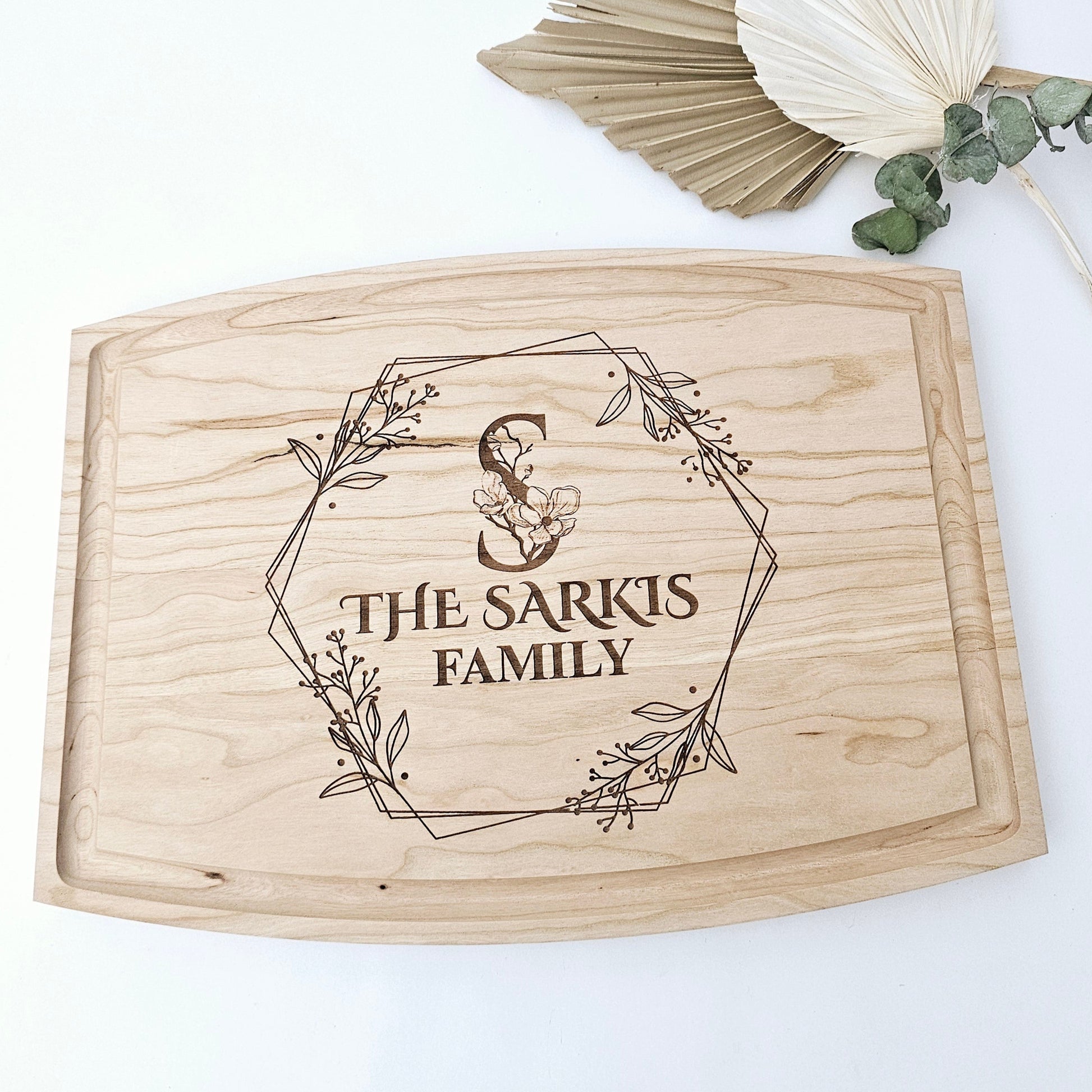 A personalized touch for any kitchen. Our cherry wood cutting board is engraved with your family name and initial, creating a unique and beautiful piece. Crafted in Montreal.
