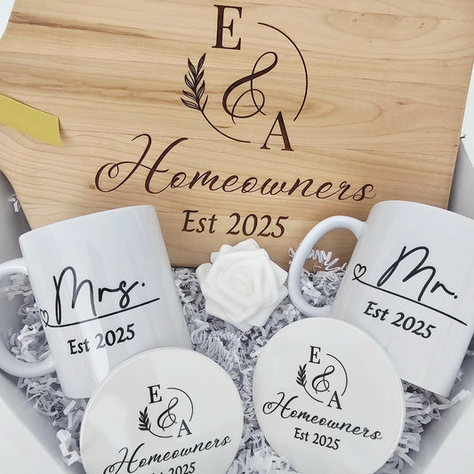 Gift set with personalized cutting board, mugs, and coasters in a box.