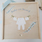Custom wooden birth announcement box for newborns featuring a watercolor clothesline with a onesie and booties.