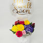 Balloon with 'Get Well Soon' text and a bouquet of flowers on a white background
