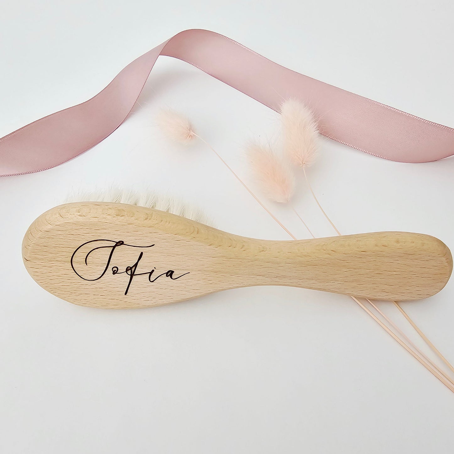 Personalized wooden baby brush with soft bristles engraved with the name Sofia in an elegant script font.