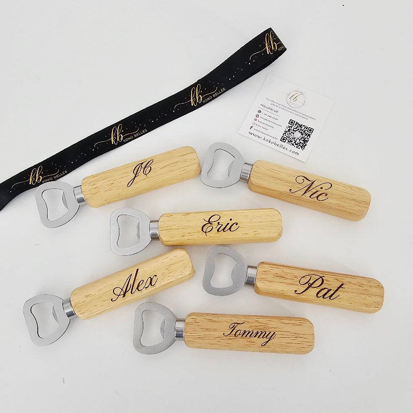Set of wooden bottle openers with engraved names on a white background