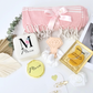Pampering gift box including a soft throw personalized jewelry storage and beauty treats
