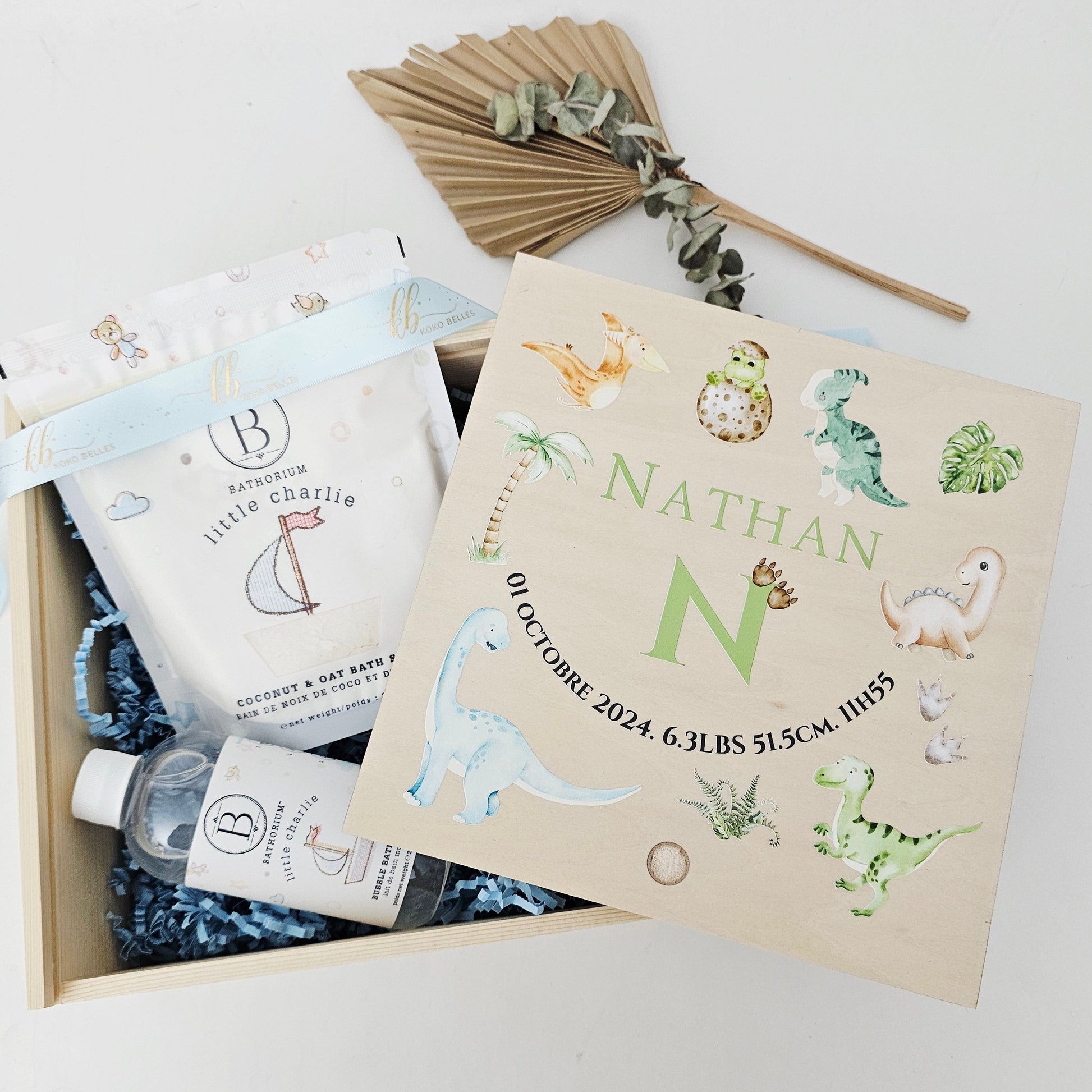 Personalized wooden baby birth announcement box with watercolor T-Rex and Triceratops dinosaurs for a boy.