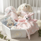 Baby gift set with plush toys and a teether in a box on a crib
