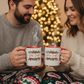 Couple with His and Hers Christmas Mugs 