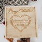 Personalized wooden holiday keepsake box engraved with a floral heart wreath, couples names, and established year.