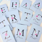 Personalized light blue journal resting on a wooden desk next to elegant stationery and office accessories.
