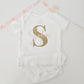 Personalized baby girl onesie with large sparkly gold glitter initial S and pink script name Sofia.