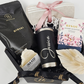 A luxury black octagonal gift box filled with a custom laser-engraved matte black tumbler featuring the name Jessica, a beige Turkish towel, Bisou Cherry Blossom green tea, Bathorium Hinoki mineral bath soak, and a handmade Buck Naked soap bar.