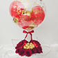 Luxury birthday gift box featuring a personalized clear bubble balloon, red roses, and chocolates.