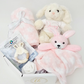 Baby gift set with plush toys and a blanket on a white background