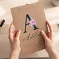 Custom wooden clipboard featuring a UV-printed floral initial A and the name Adeline on the back.